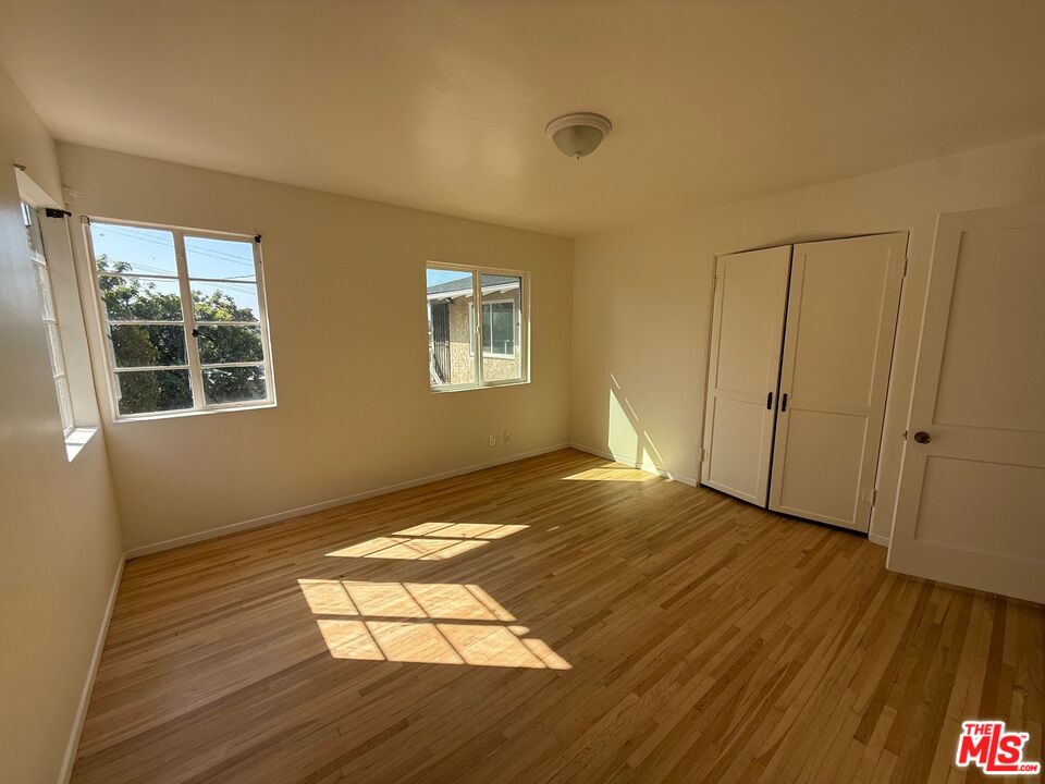 3237 Midvale Avenue Los Angeles, CA 90034 - Photo 18 of 24 a view of empty room with wooden floor and fan