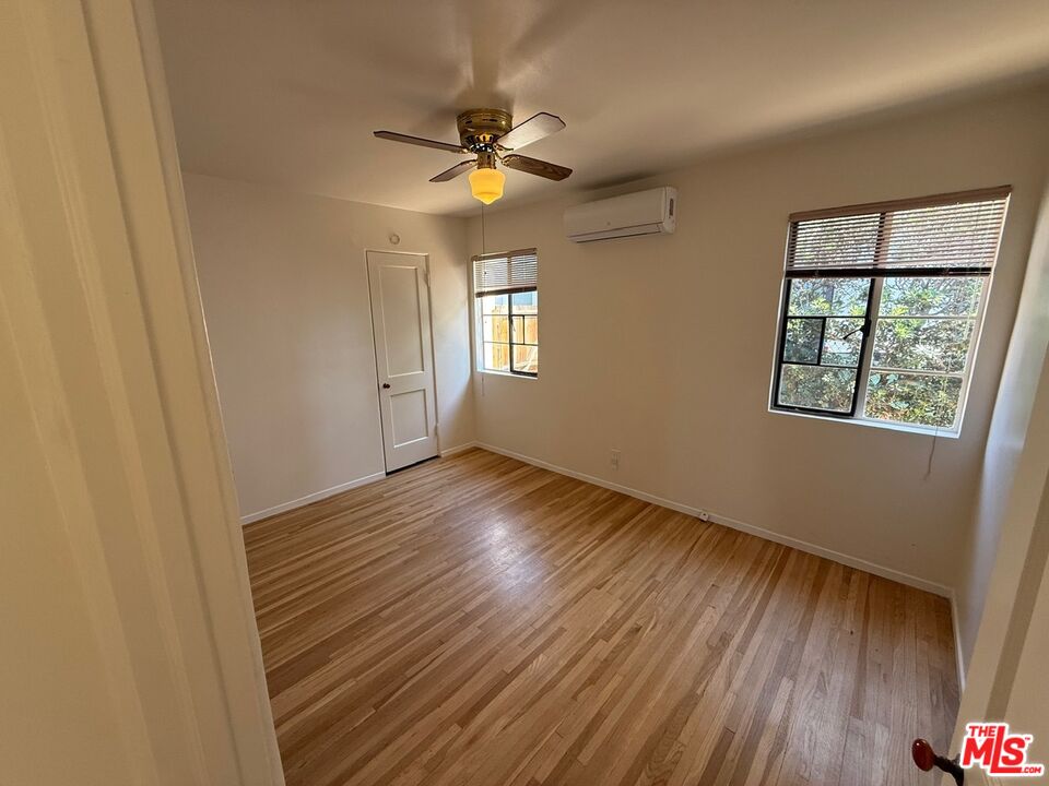 3237 Midvale Avenue Los Angeles, CA 90034 - Photo 19 of 24 a view of an empty room with wooden floor and a window