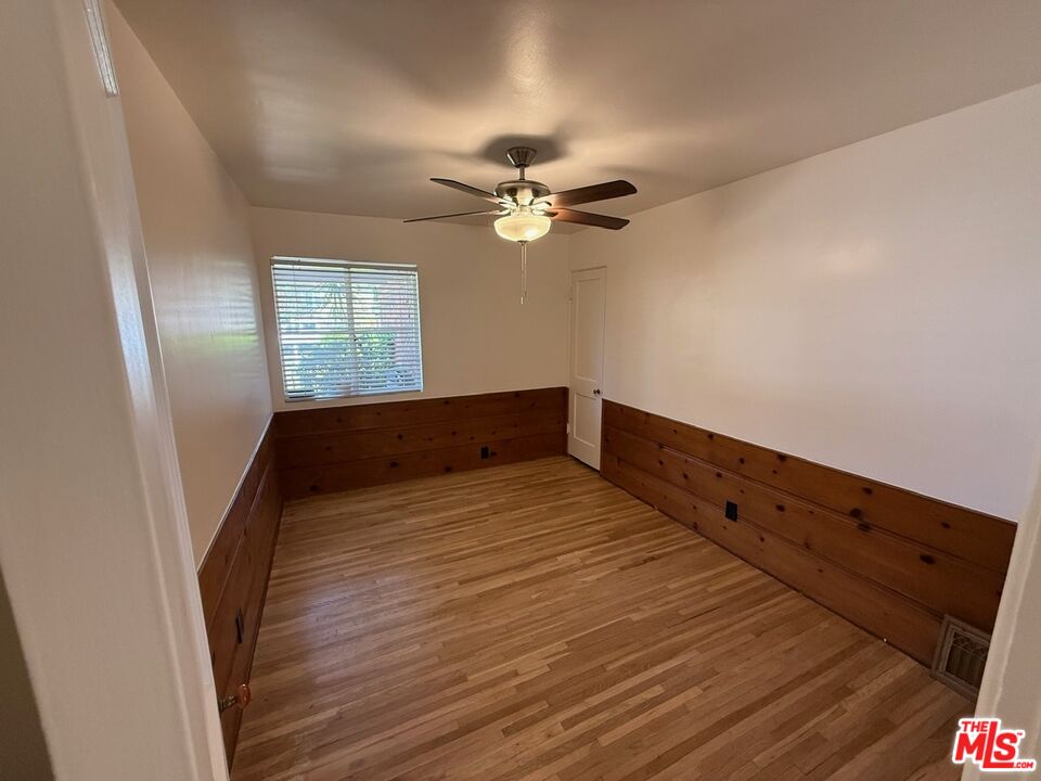 3237 Midvale Avenue Los Angeles, CA 90034 - Photo 20 of 24 a view of a room with wooden floor and a ceiling fan