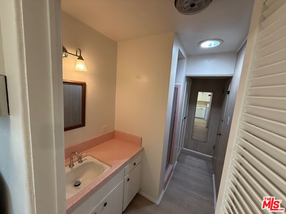 3237 Midvale Avenue Los Angeles, CA 90034 - Photo 21 of 24 a bathroom with a granite countertop sink and a mirror