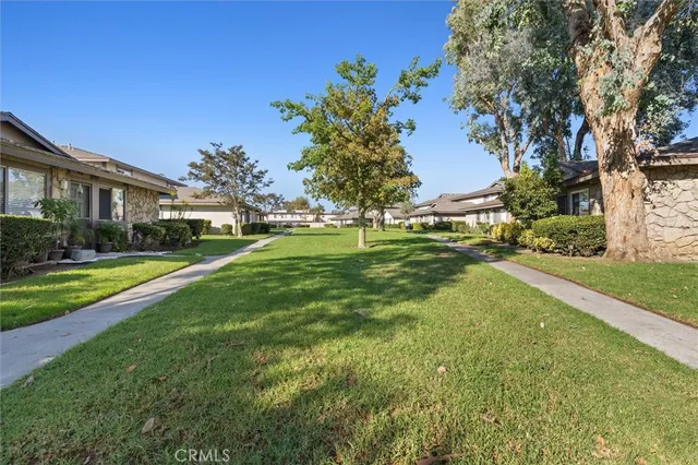 a view of yard with swimming pool and green space
