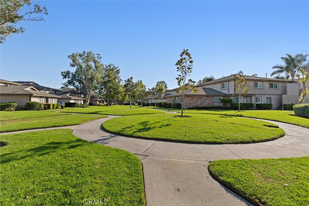 1723 Normandy Place, Unit D Santa Ana, CA 92705 - Photo 16 of 18 a view of a golf course with a garden