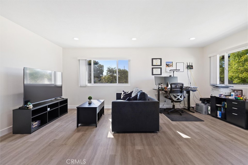 1723 Normandy Place, Unit D Santa Ana, CA 92705 - Photo 8 of 18 a living room with furniture and a flat screen tv