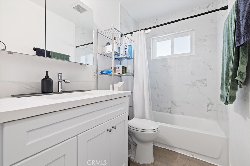 1723 Normandy Place, Unit D Santa Ana, CA 92705 - Photo 9 of 18 a bathroom with a sink a toilet and a bathtub