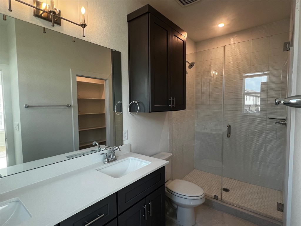 200 West 56th Street, Unit 5101 Austin, TX 78751 - Photo 8 of 14 a bathroom with a sink a toilet and shower