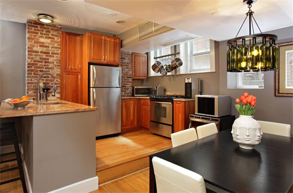 a kitchen with stainless steel appliances granite countertop a sink dishwasher and a refrigerator with wooden floor