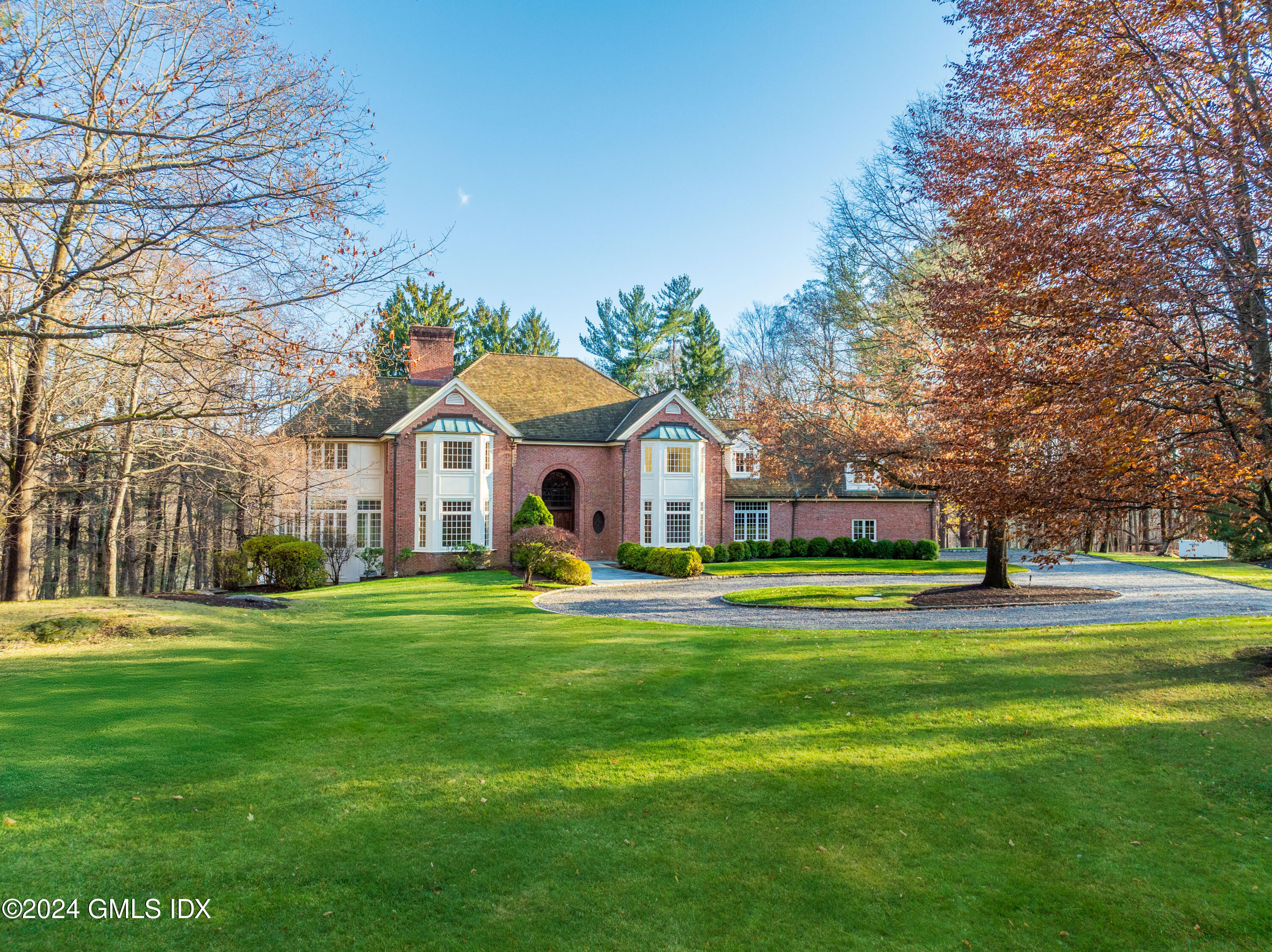 534 Stanwich Road Greenwich, CT 06831 - Photo 1 of 30 a view of a white house with a big yard and large trees