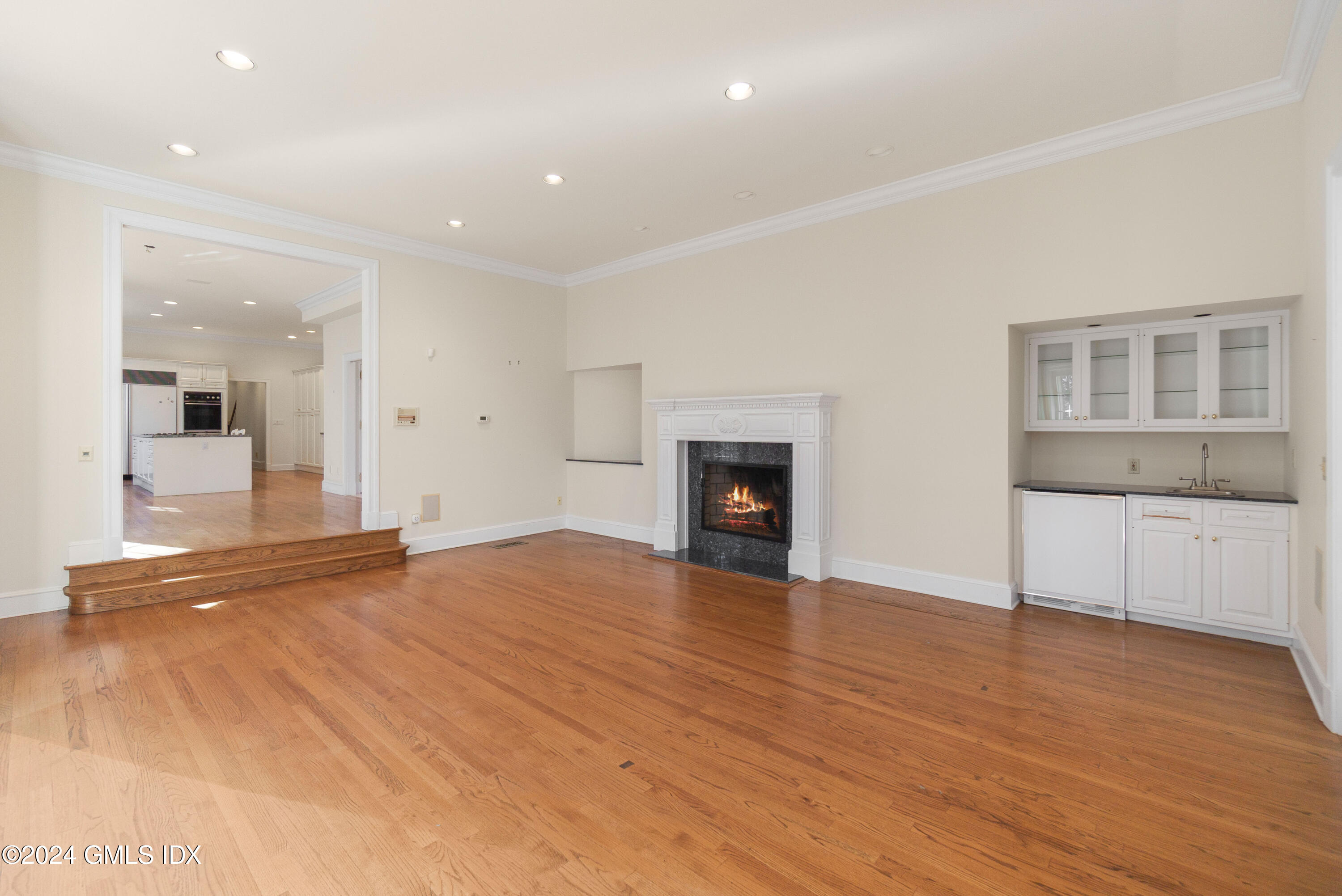 534 Stanwich Road Greenwich, CT 06831 - Photo 13 of 30 a view of empty room with wooden floor and fireplace