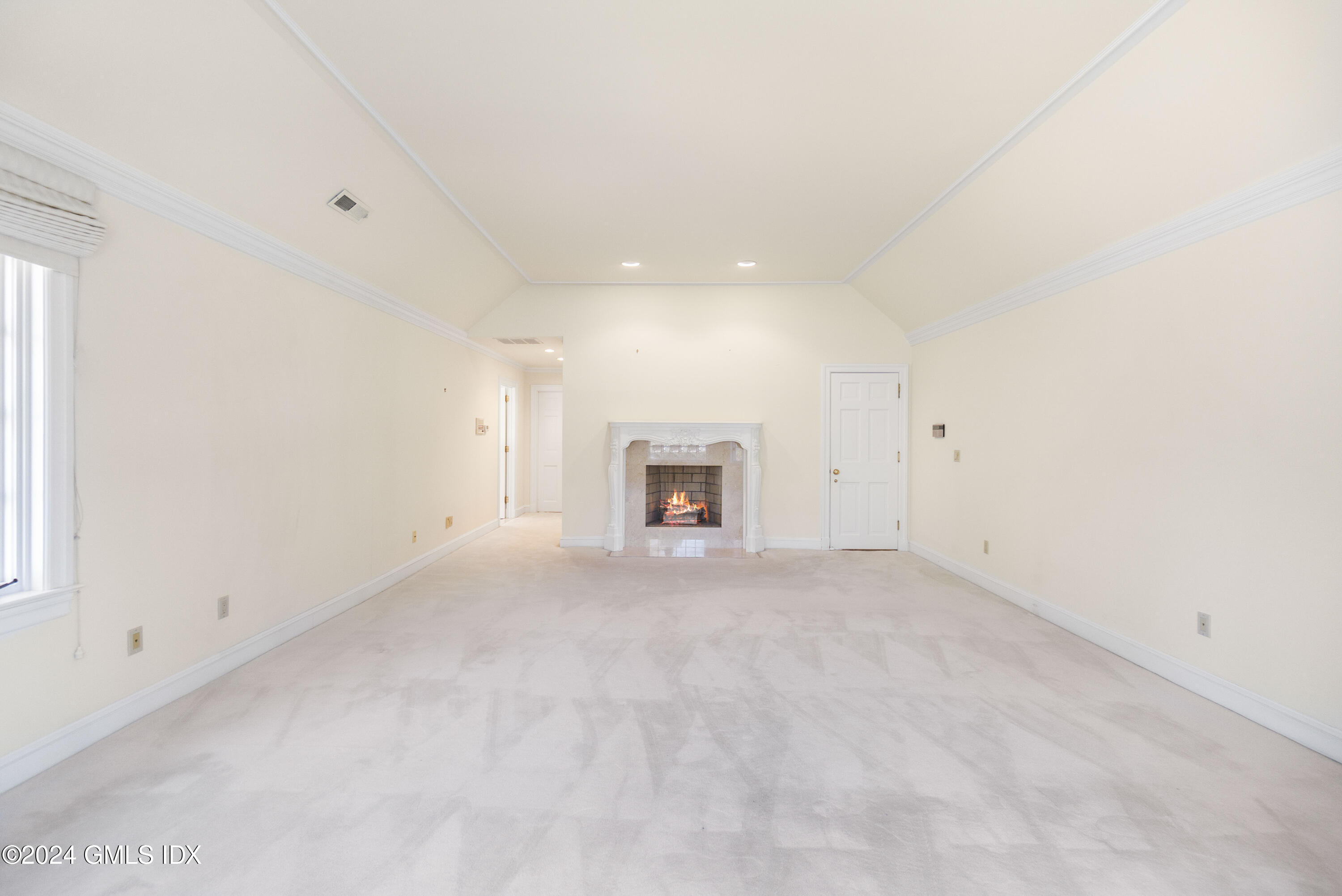 534 Stanwich Road Greenwich, CT 06831 - Photo 18 of 30 an empty room with a fireplace and a window