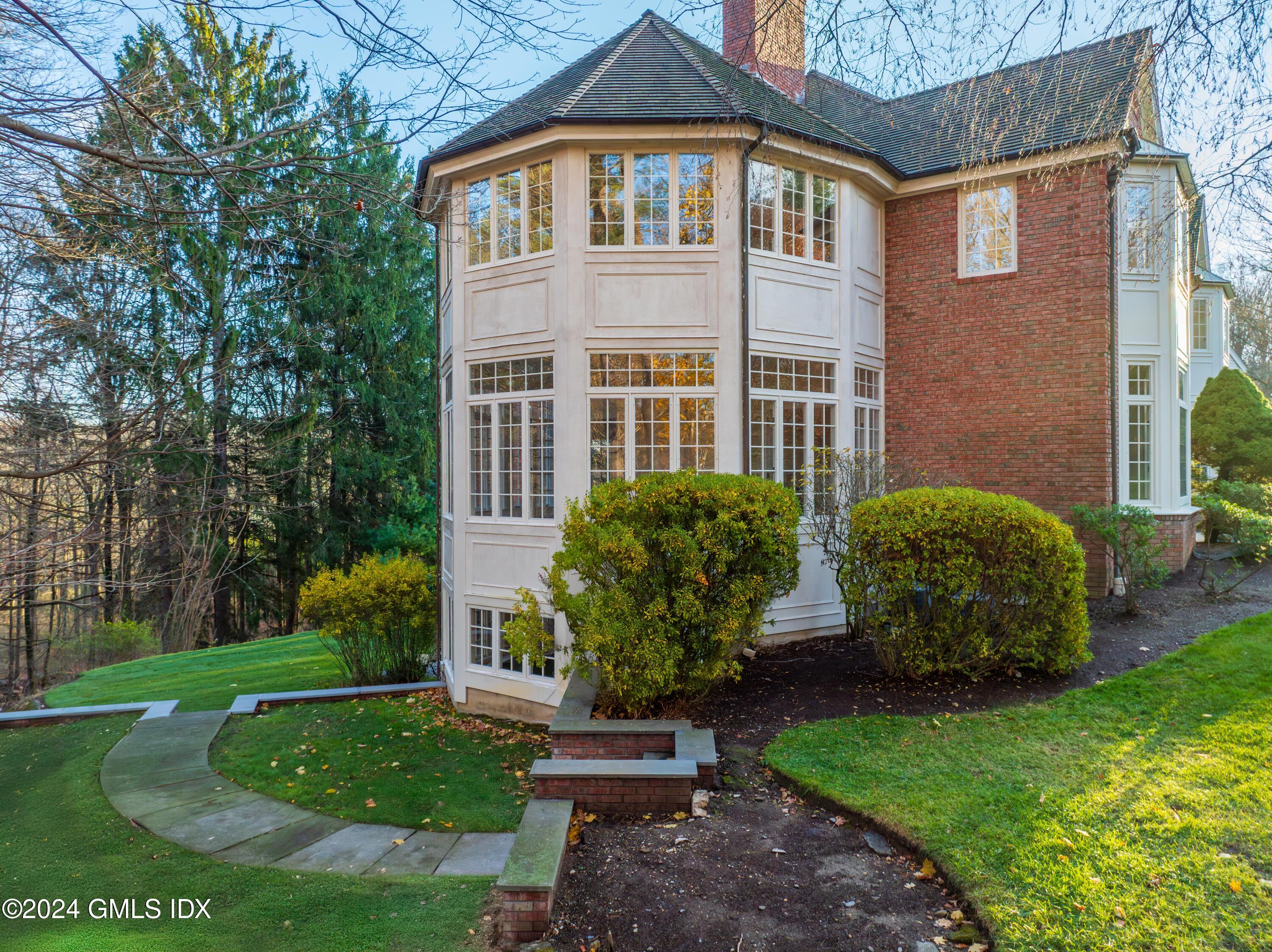 534 Stanwich Road Greenwich, CT 06831 - Photo 23 of 30 a front view of a house with garden