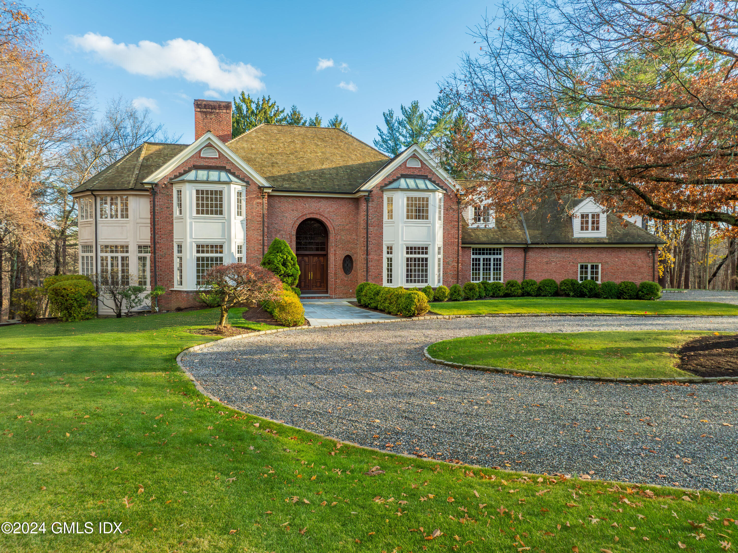 534 Stanwich Road Greenwich, CT 06831 - Photo 4 of 30 a front view of a house with a yard