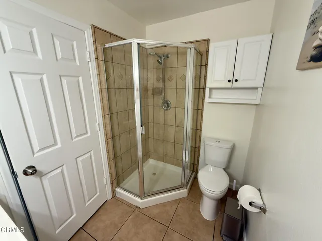 a bathroom with a toilet and a shower