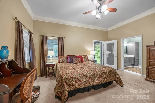 a bedroom with a bed couch and a flat tv screen