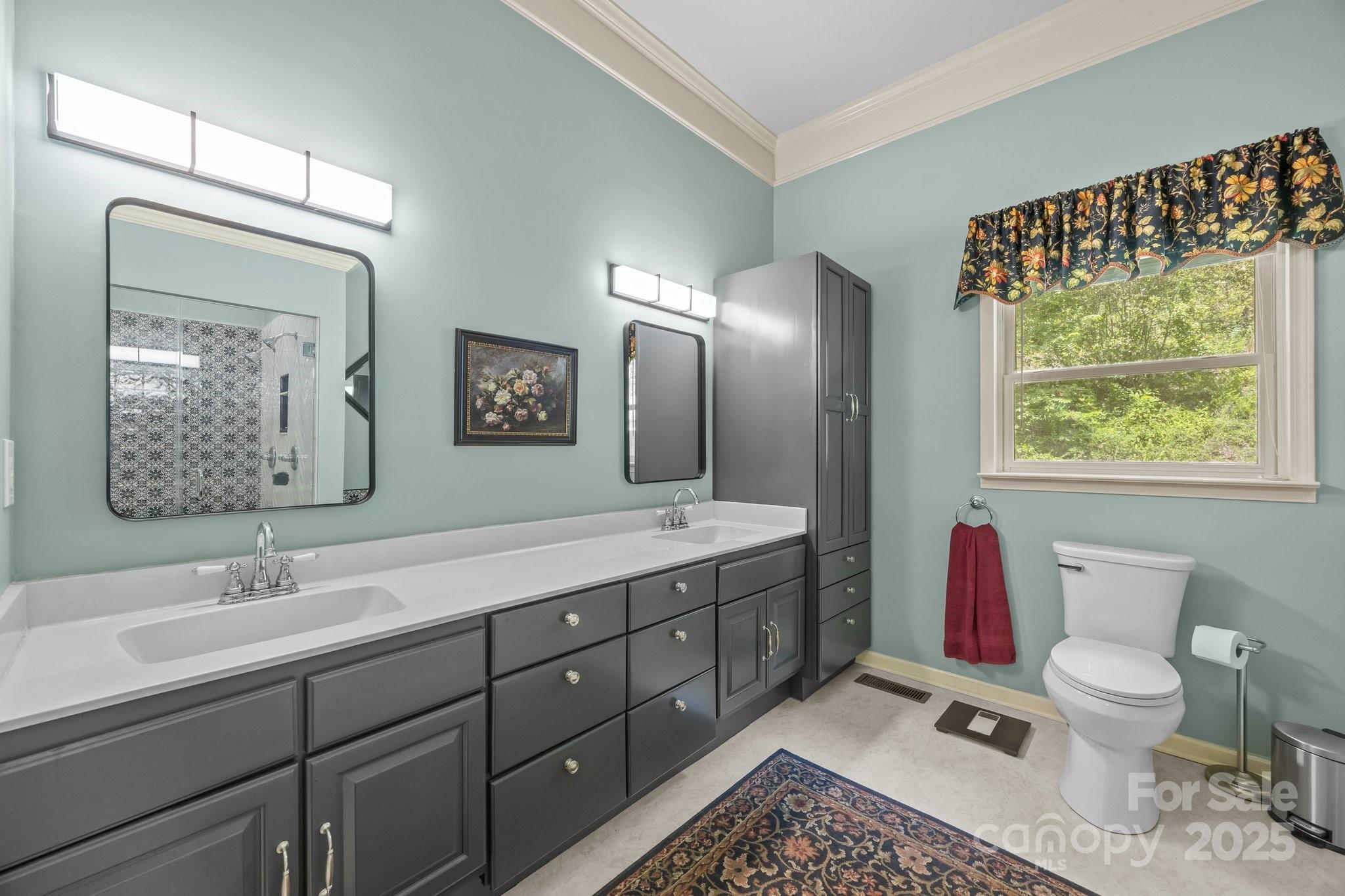 235 Kinder Lane Canton, NC 28716 - Photo 20 of 48 a spacious bathroom with a toilet sink and mirror