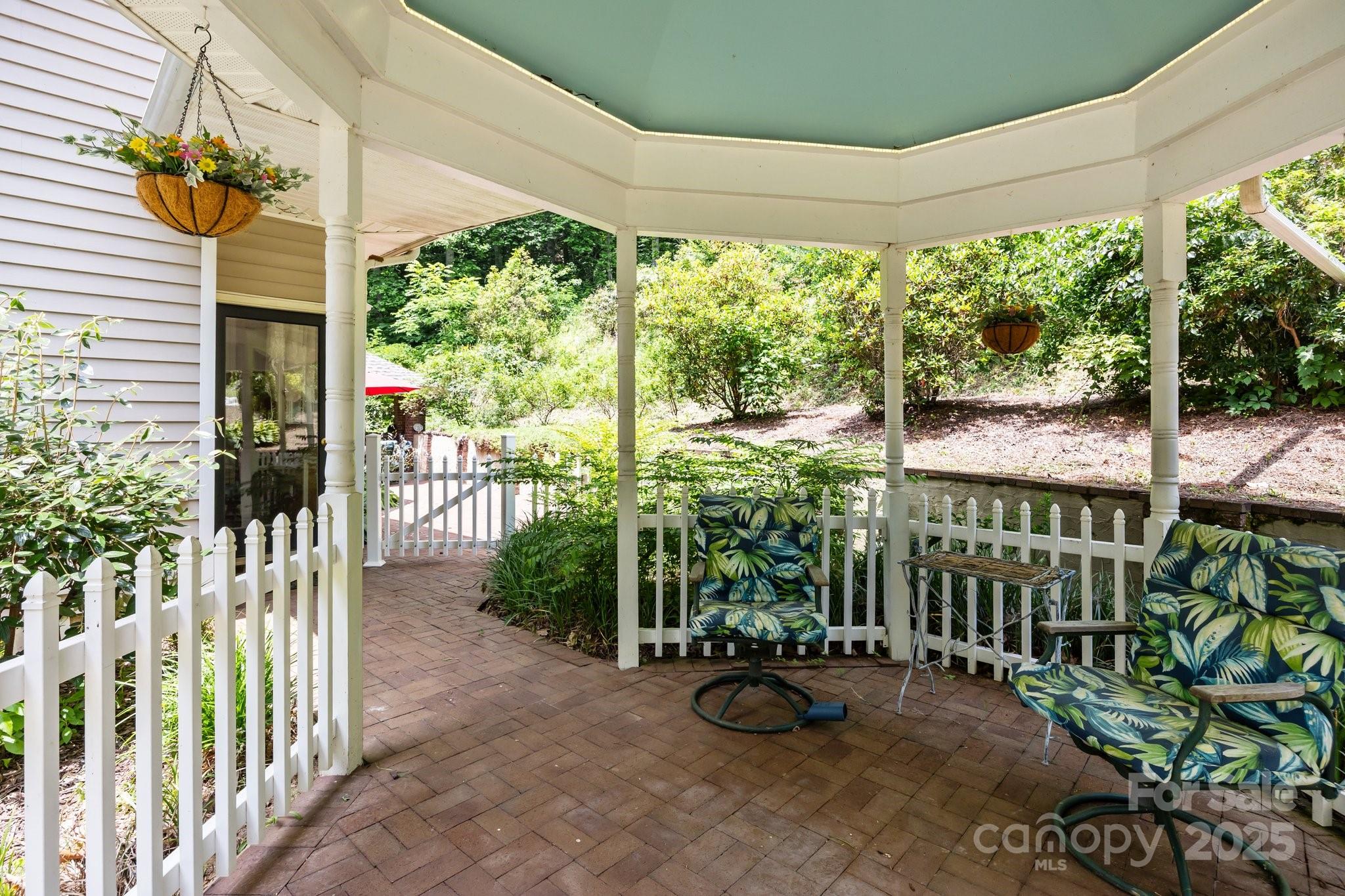 235 Kinder Lane Canton, NC 28716 - Photo 35 of 48 a view of a porch with chairs and plants