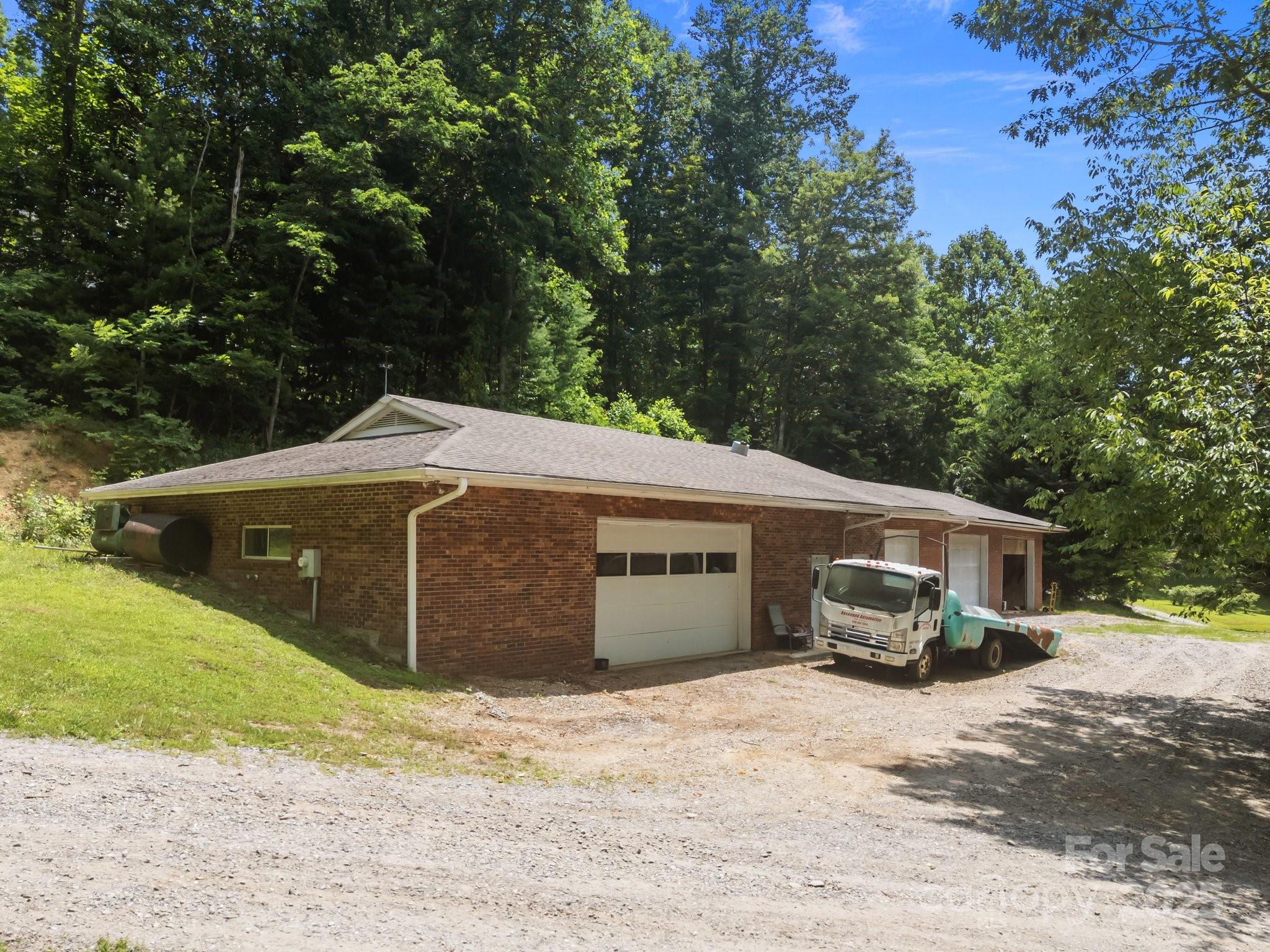 235 Kinder Lane Canton, NC 28716 - Photo 46 of 48 a front view of a house with a garden