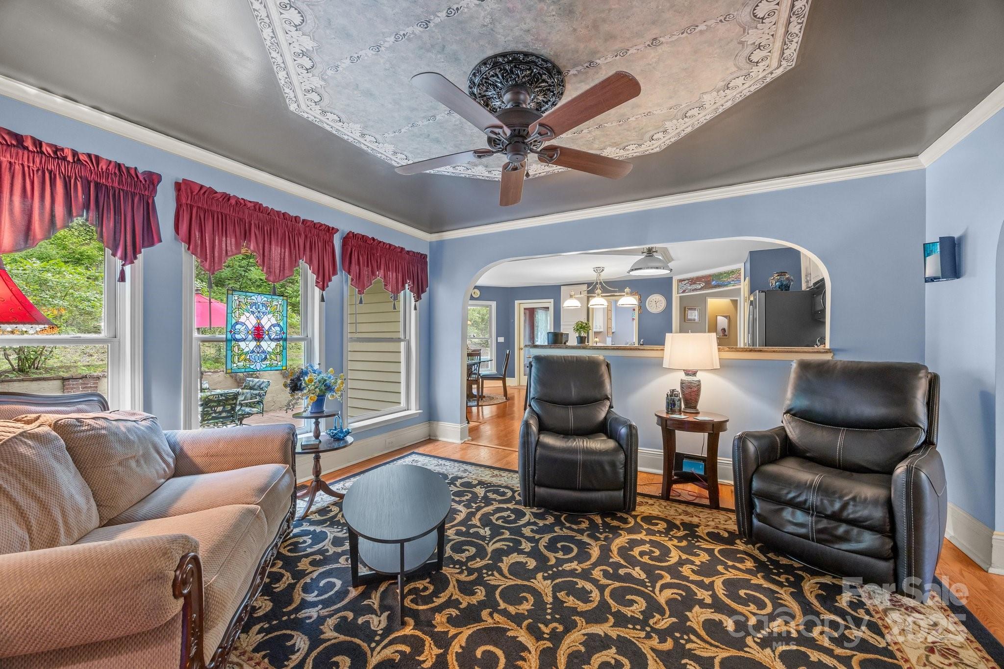235 Kinder Lane Canton, NC 28716 - Photo 7 of 48 a living room with furniture ceiling fan and a rug