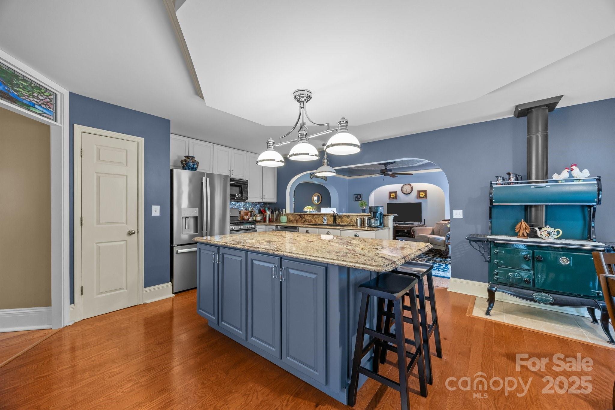 235 Kinder Lane Canton, NC 28716 - Photo 9 of 48 a kitchen with stainless steel appliances granite countertop a stove a refrigerator a sink dishwasher with a dining table and chairs
