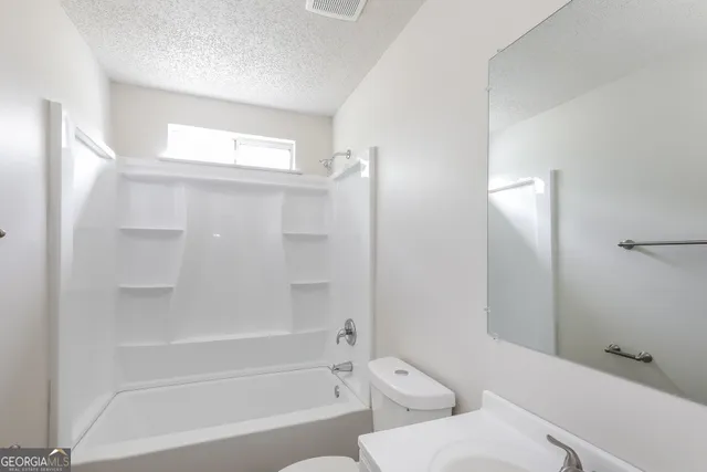 a bathroom with a toilet and a bathtub