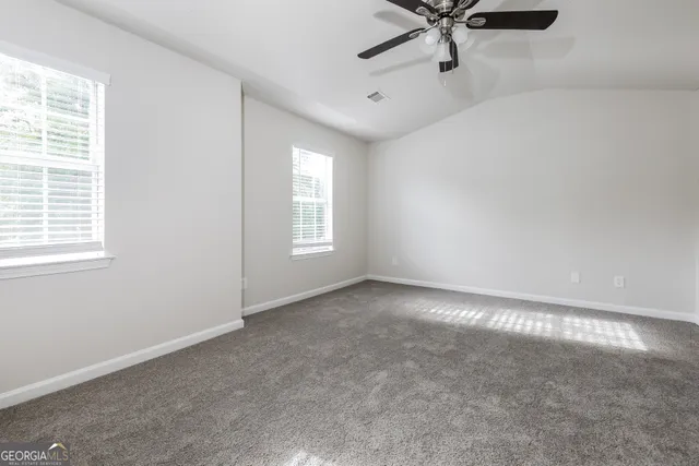 a view of a livingroom with a ceiling fan and window