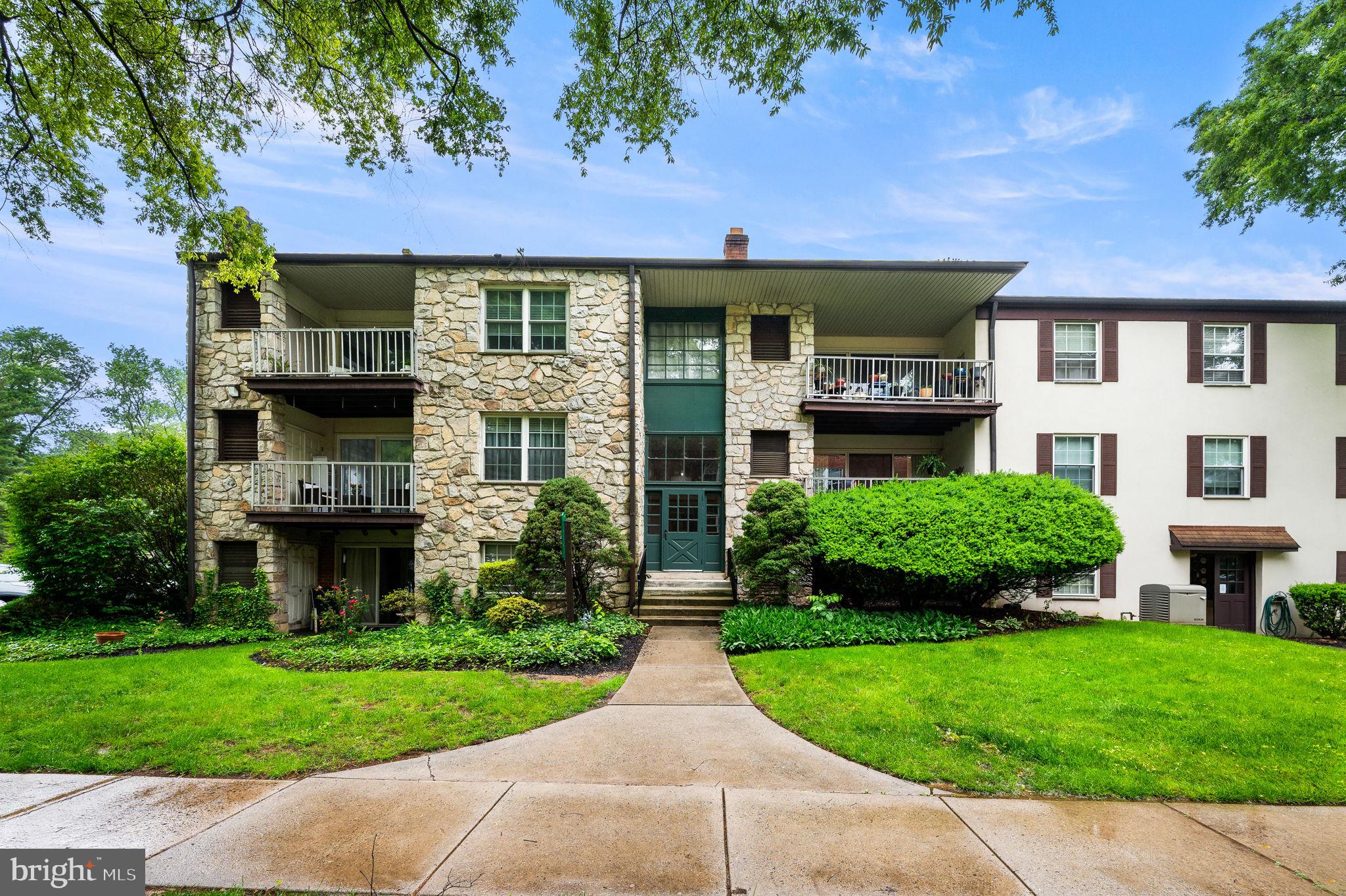 288 Drummers Lane, Unit 288 Wayne, PA 19087 - Photo 2 of 30 front view of a house with a yard