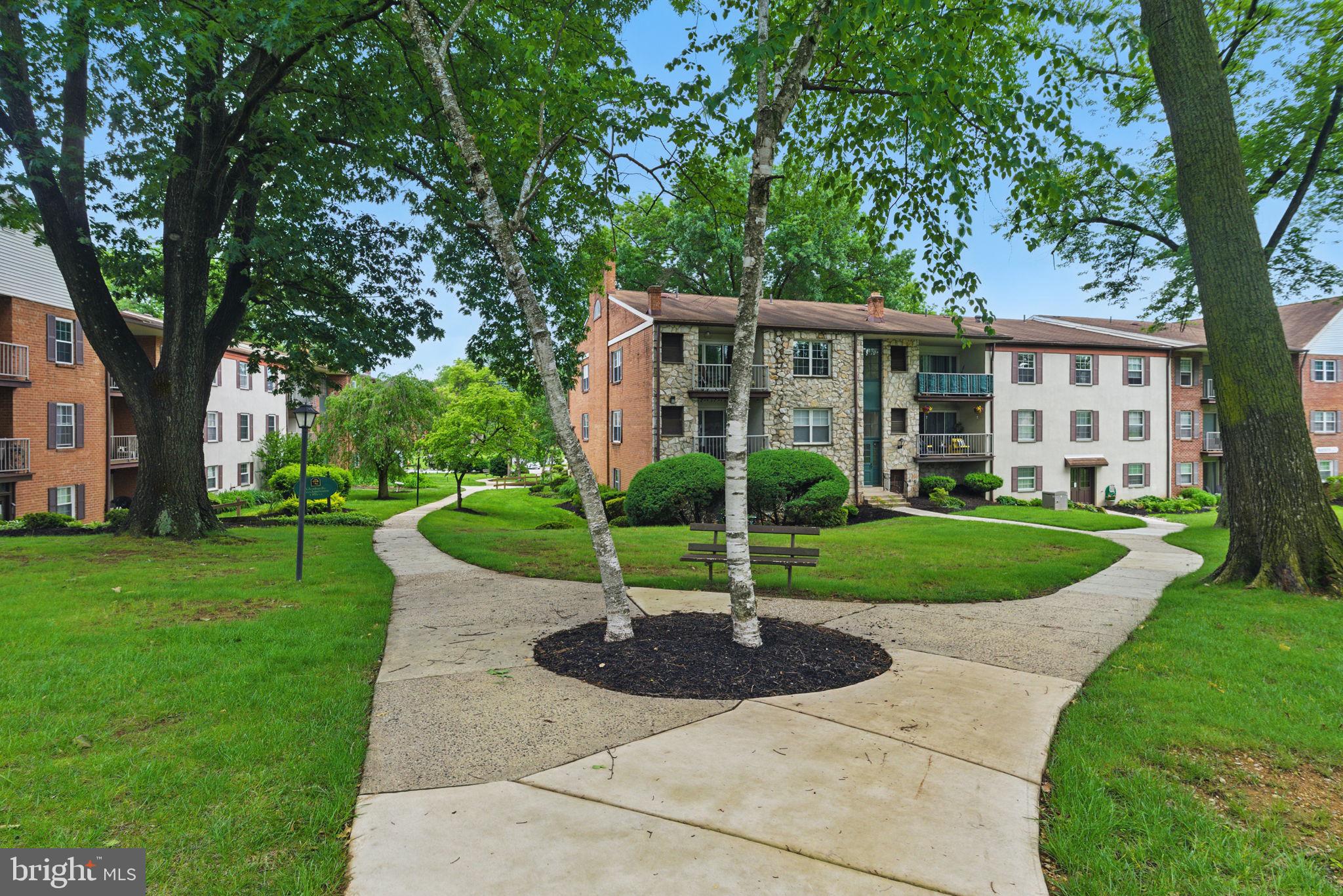 288 Drummers Lane, Unit 288 Wayne, PA 19087 - Photo 29 of 30 a front view of a house with a yard and trees