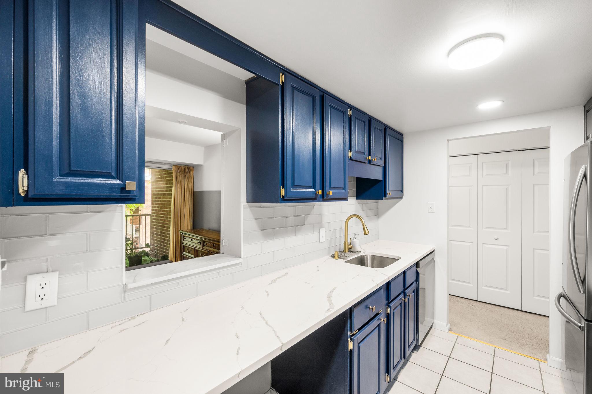 288 Drummers Lane, Unit 288 Wayne, PA 19087 - Photo 6 of 30 a kitchen with a sink cabinets and a window