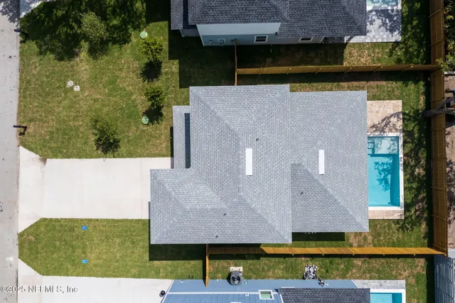 an aerial view of a house with a yard