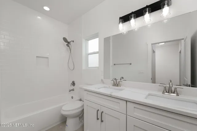 a bathroom with a double vanity sink and a mirror