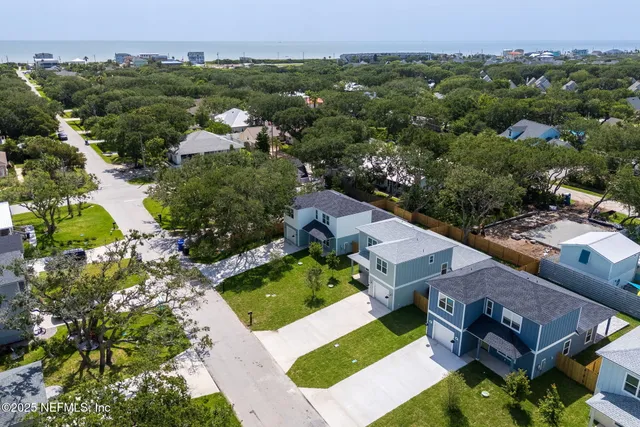 an aerial view of a house with swimming pool and mountains