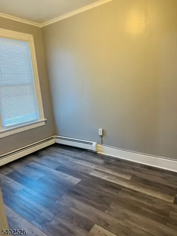 a view of a room with wooden floor and entrance