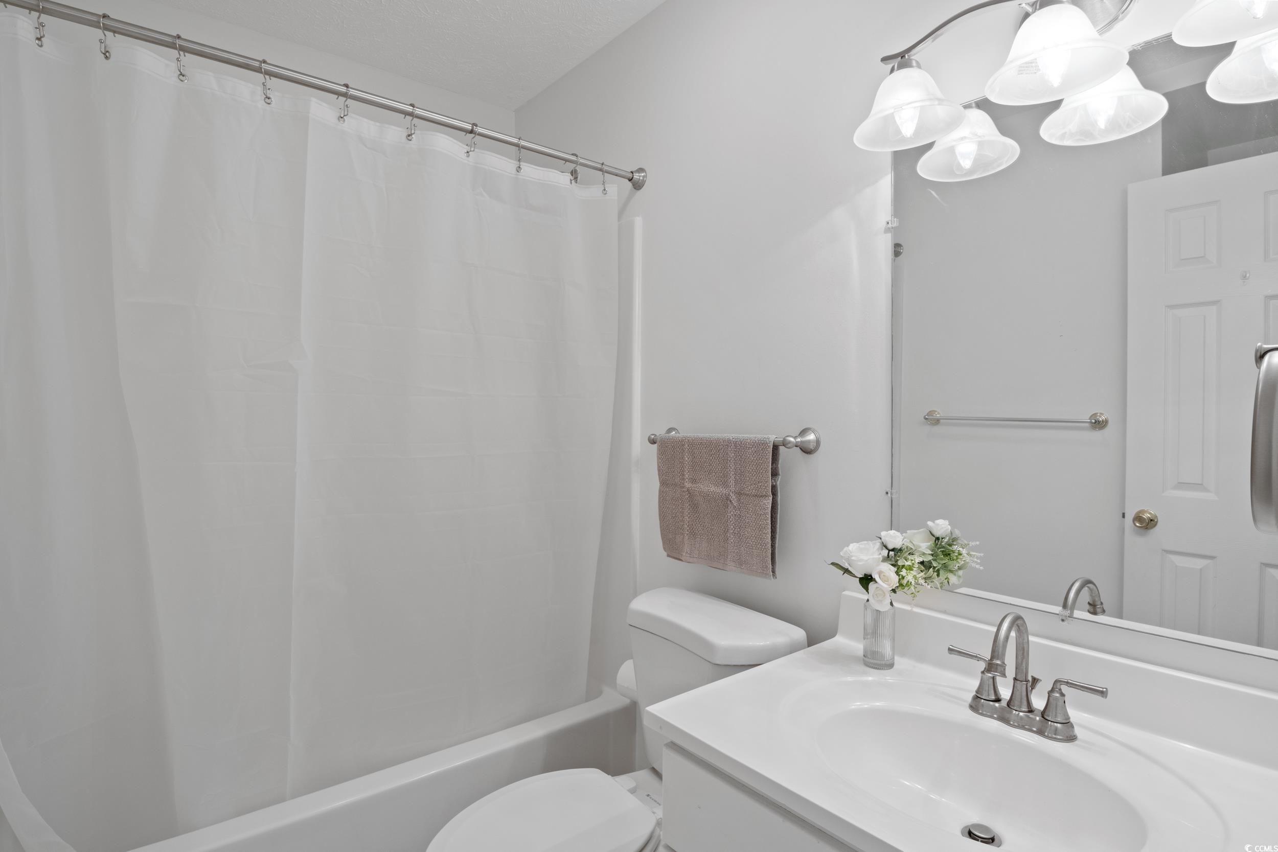 5933 Rahnavard Boulevard Myrtle Beach, SC 29588 - Photo 11 of 25 Full bathroom with toilet, vanity, and shower / tu