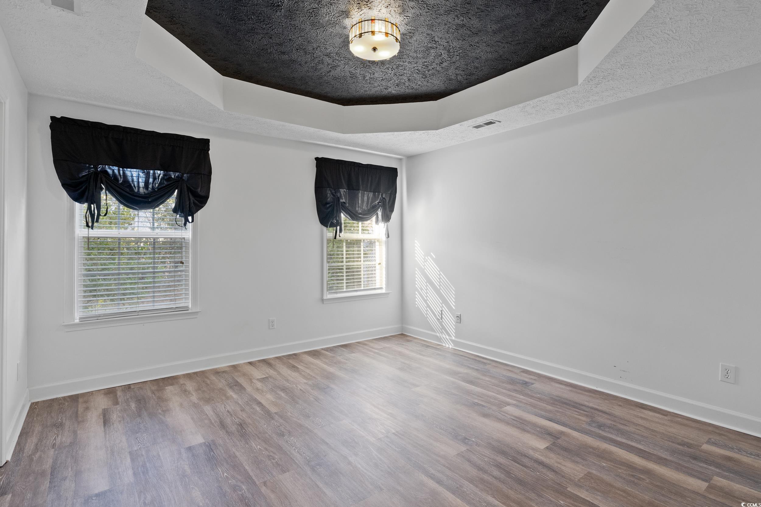 5933 Rahnavard Boulevard Myrtle Beach, SC 29588 - Photo 14 of 25 Empty room featuring hardwood / wood-style floorin