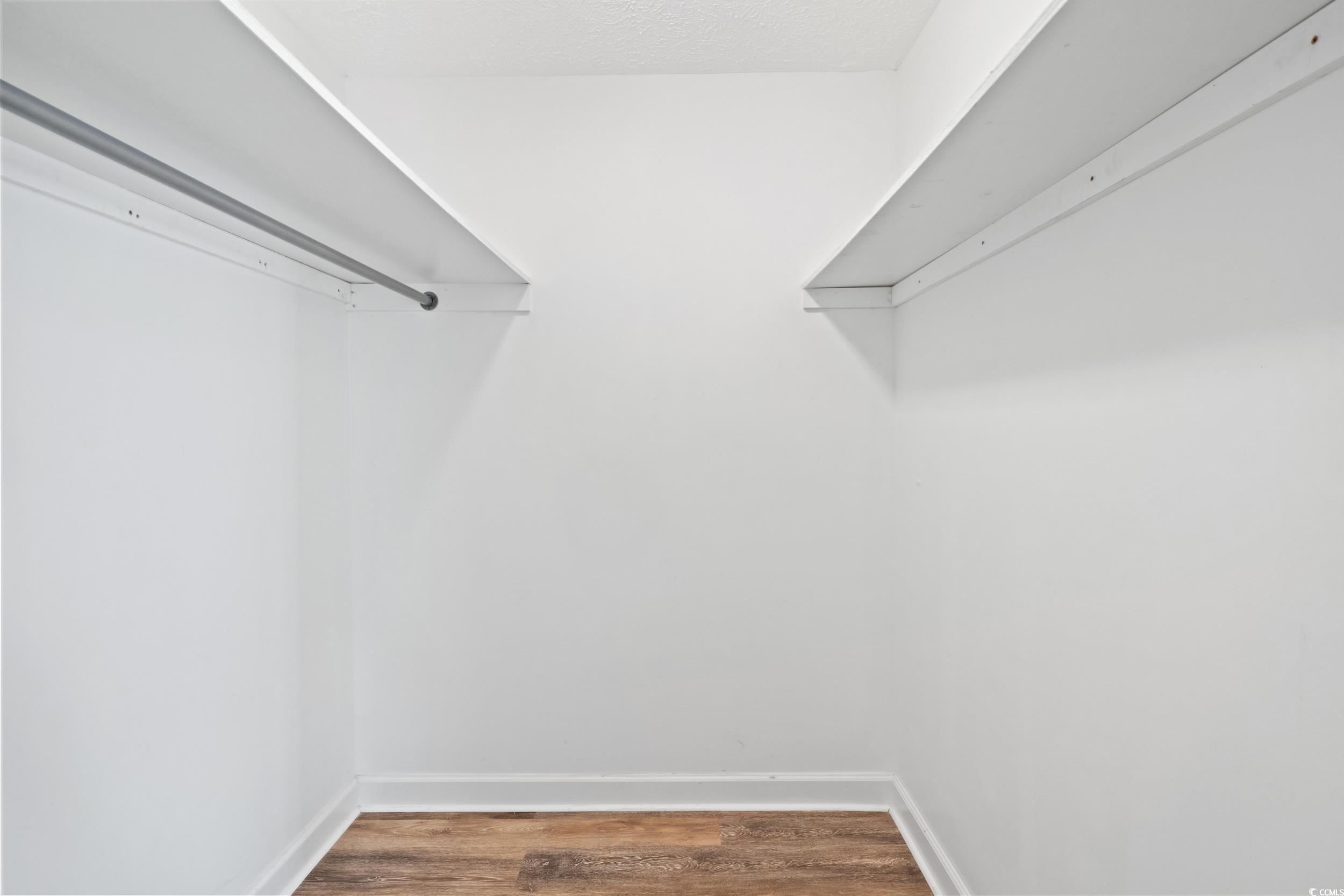 5933 Rahnavard Boulevard Myrtle Beach, SC 29588 - Photo 16 of 25 Walk in closet with wood-type flooring