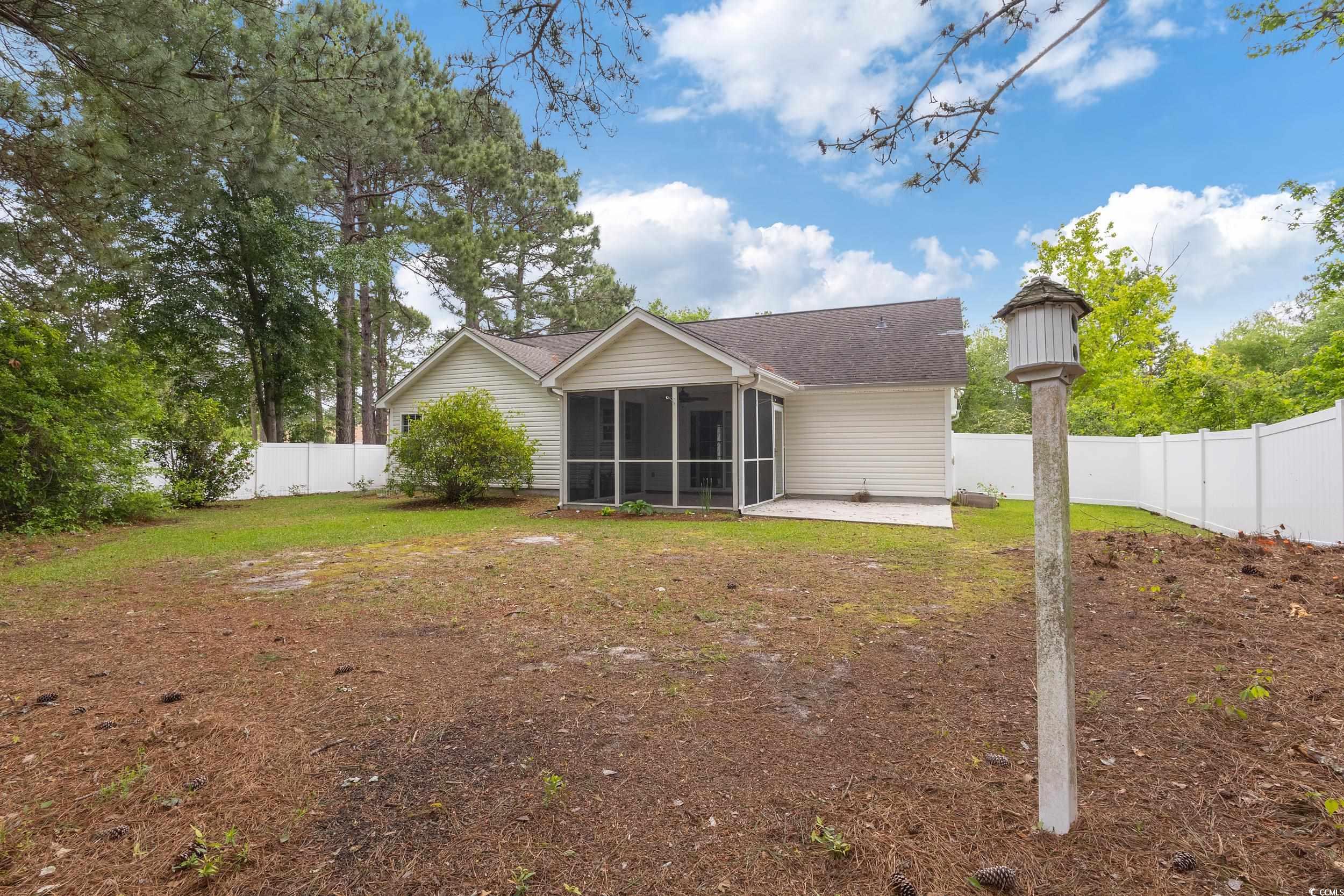 5933 Rahnavard Boulevard Myrtle Beach, SC 29588 - Photo 20 of 25 Rear view of property featuring a patio area, a fe