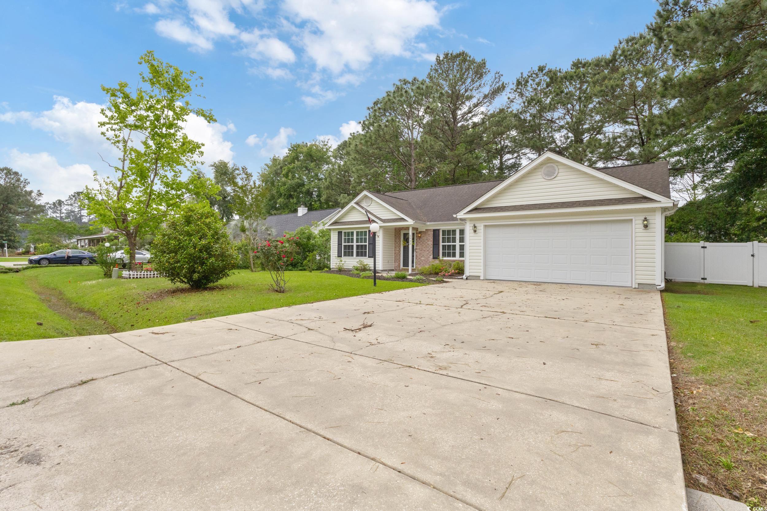 5933 Rahnavard Boulevard Myrtle Beach, SC 29588 - Photo 3 of 25 Single story home featuring a gate, fence, a garag