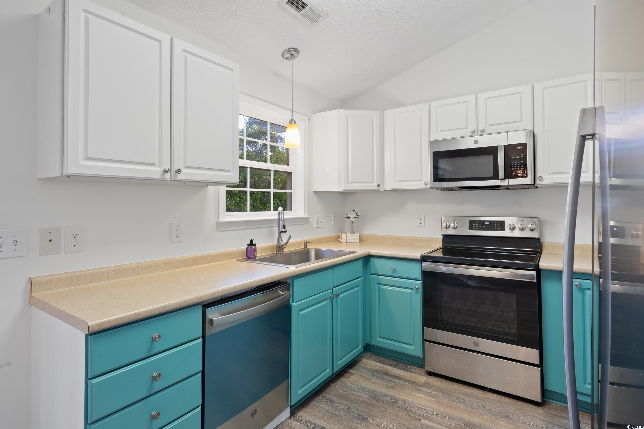 5933 Rahnavard Boulevard Myrtle Beach, SC 29588 - Photo 9 of 25 Kitchen featuring stainless steel appliances, blue