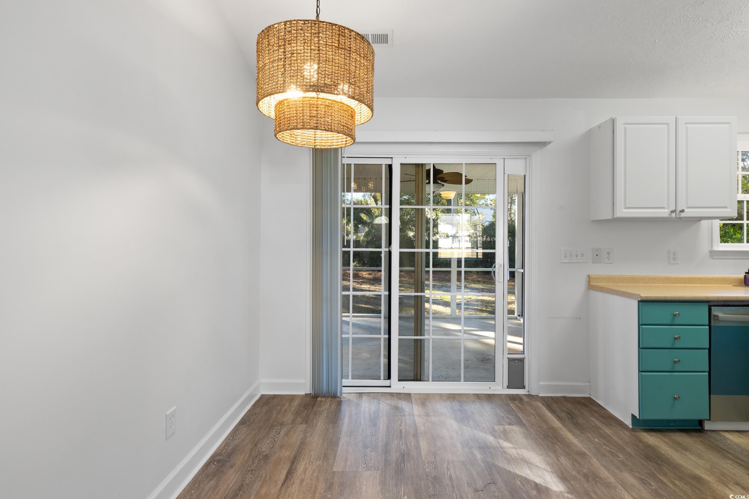 5933 Rahnavard Boulevard Myrtle Beach, SC 29588 - Photo 10 of 25 Unfurnished dining area with plenty of natural lig