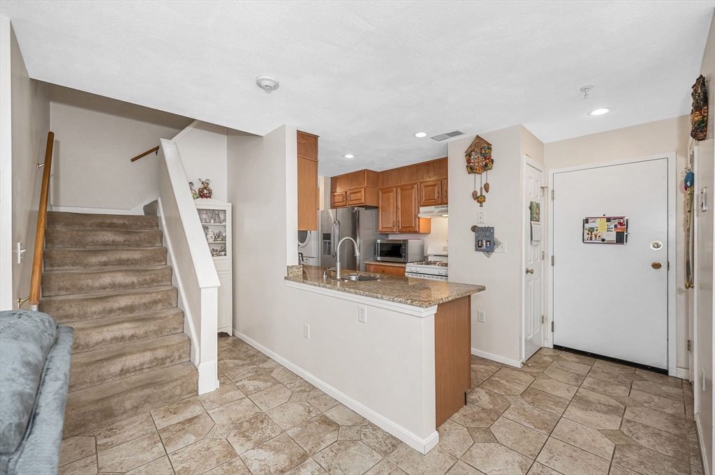 39 Broadway, Unit 305 Malden, MA 02148 - Photo 10 of 36 a view of a kitchen with wooden floor and electronic appliances