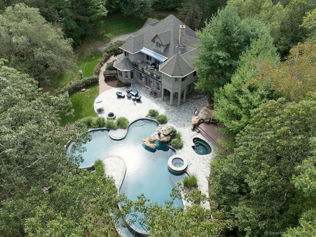 an aerial view of a house with table and chairs