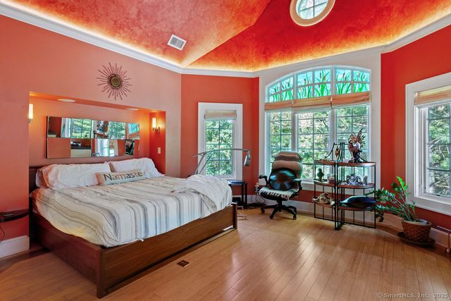 a bedroom with a bed and glass window