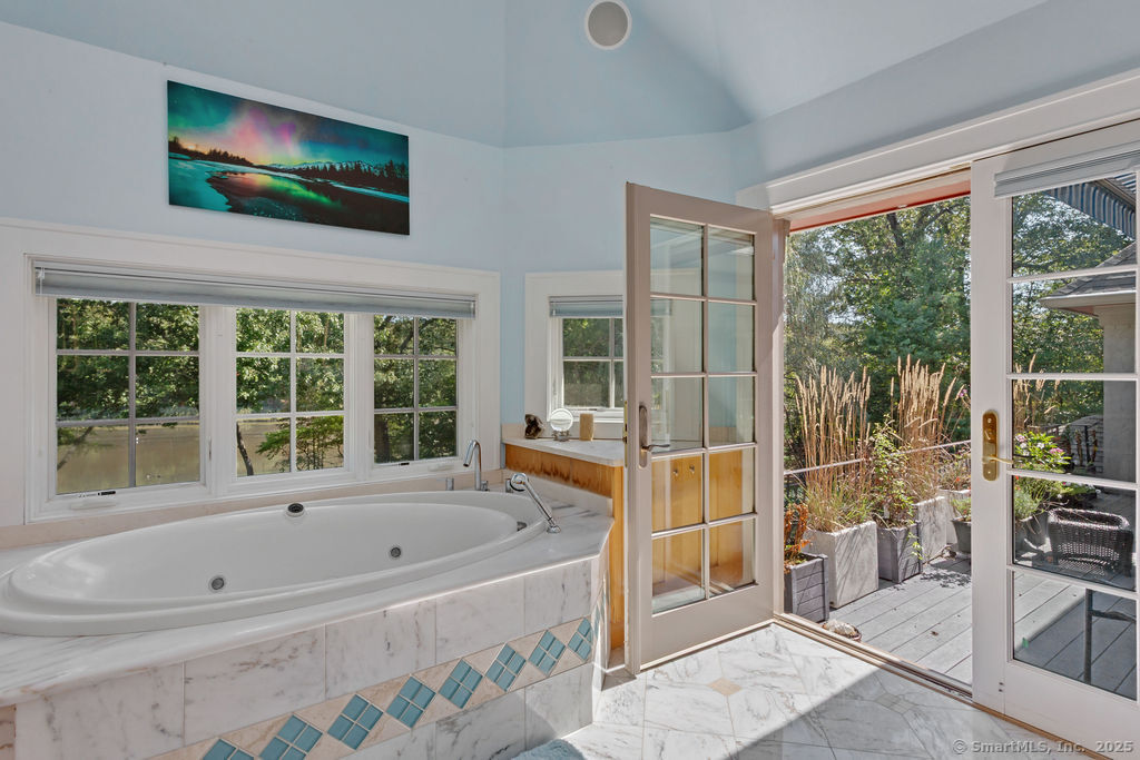 76 Sachem Head Road Guilford, CT 06437 - Photo 20 of 40 a bathroom with a bathtub and next to a window