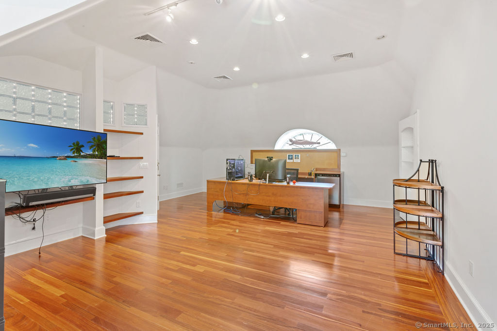 76 Sachem Head Road Guilford, CT 06437 - Photo 26 of 40 a living room with furniture and a wooden floor