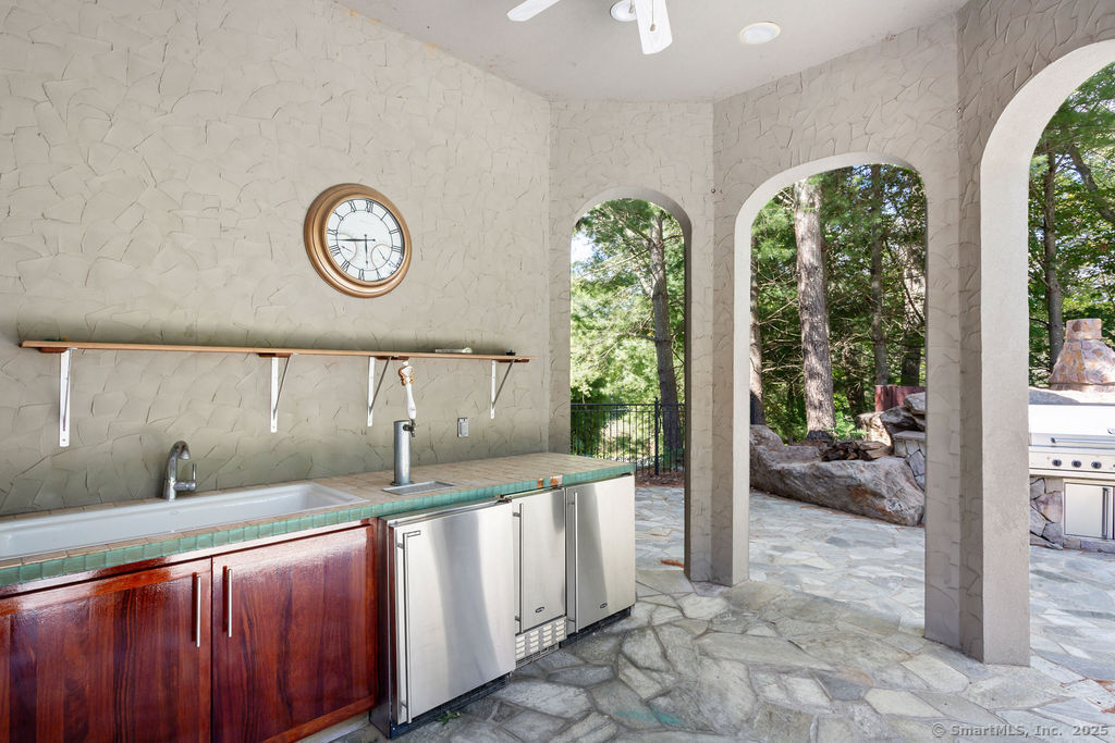 76 Sachem Head Road Guilford, CT 06437 - Photo 36 of 40 a kitchen with large windows and a sink