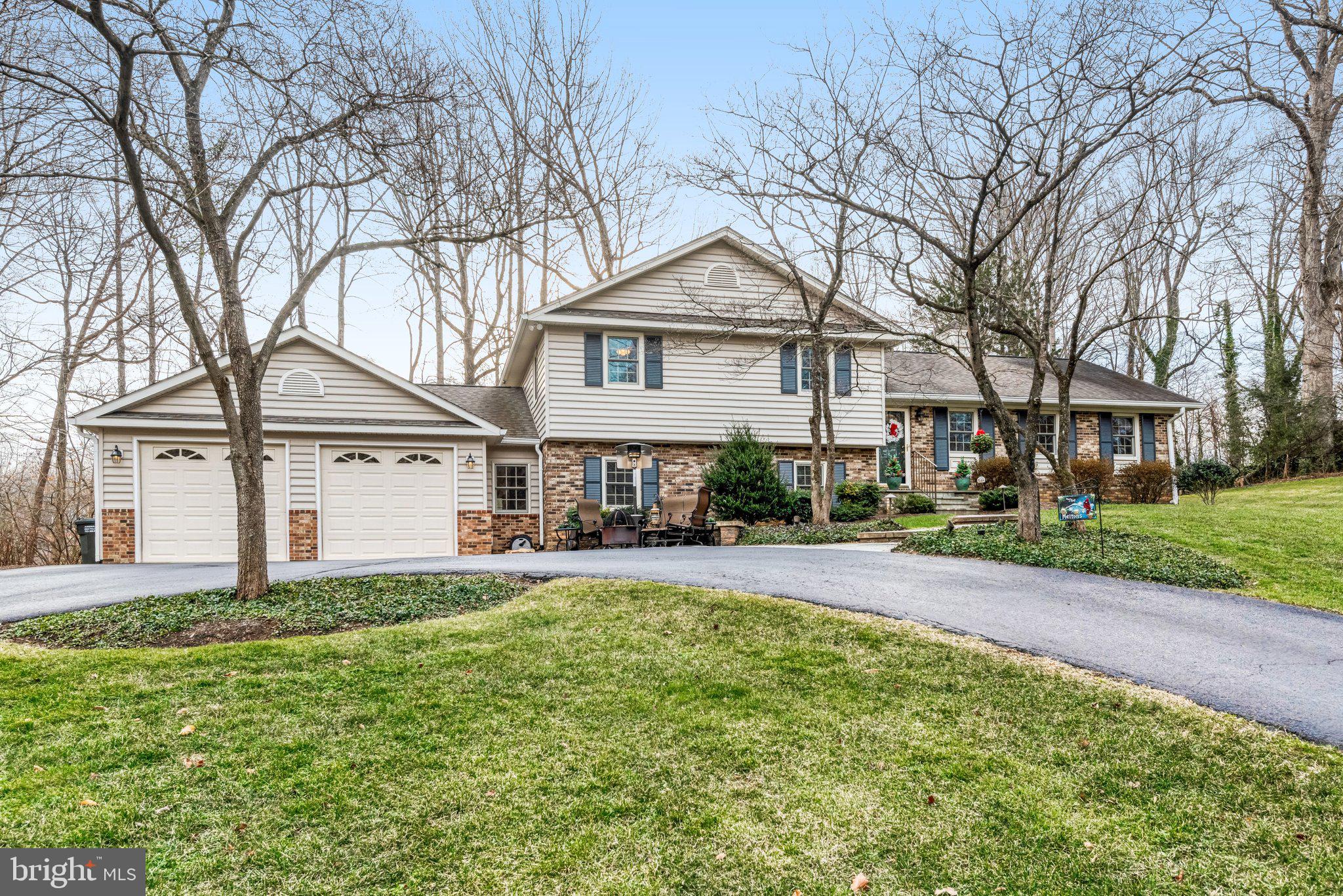 10111 Evans Ford Road Manassas, VA 20111 - Photo 1 of 35 a front view of a house with a yard and large tree