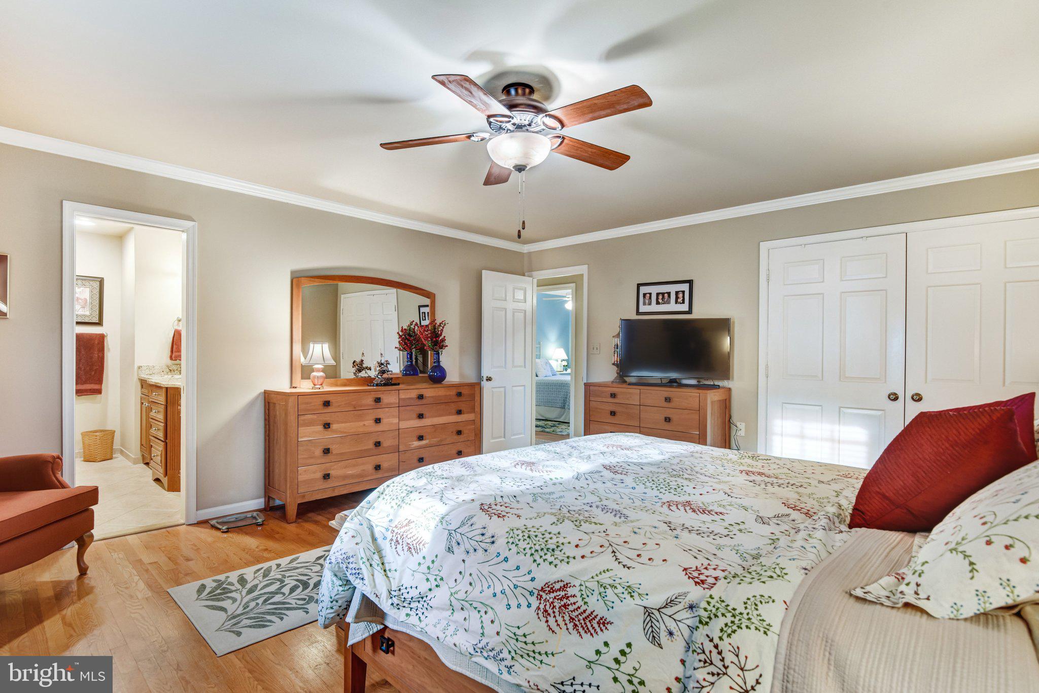 10111 Evans Ford Road Manassas, VA 20111 - Photo 13 of 35 a bedroom with a bed and dresser with mirror