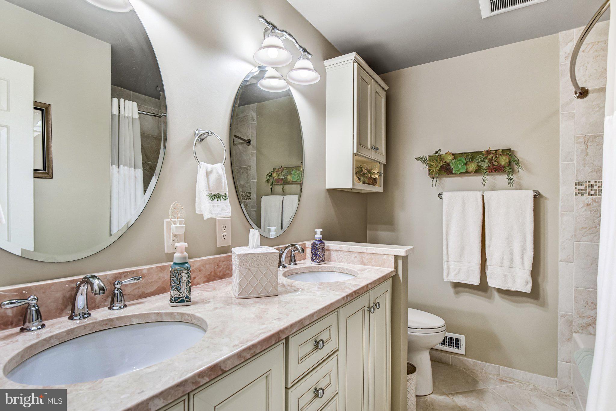 10111 Evans Ford Road Manassas, VA 20111 - Photo 17 of 35 a bathroom with a double vanity sink and a mirror