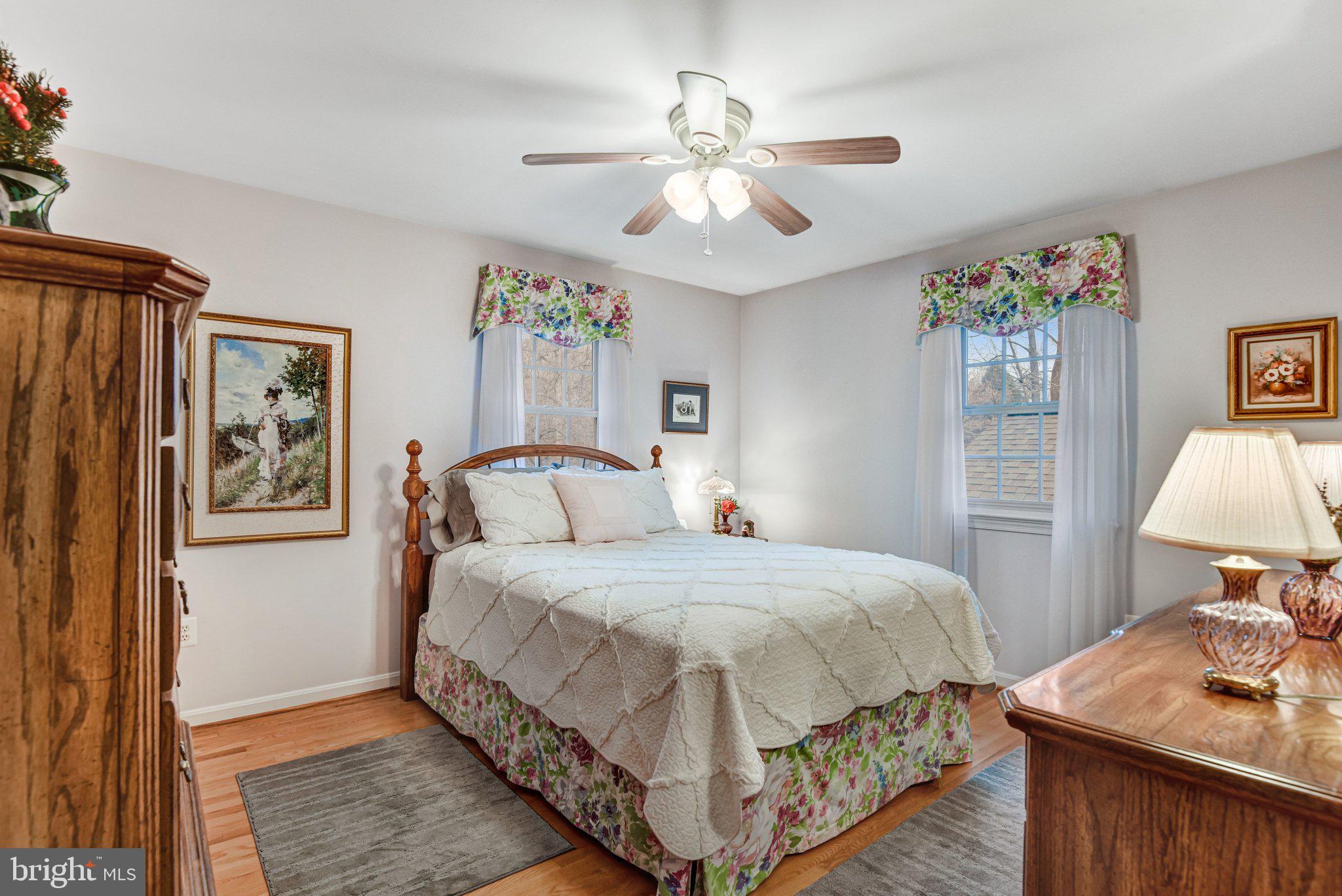 10111 Evans Ford Road Manassas, VA 20111 - Photo 18 of 35 a bedroom with a bed and a chandelier