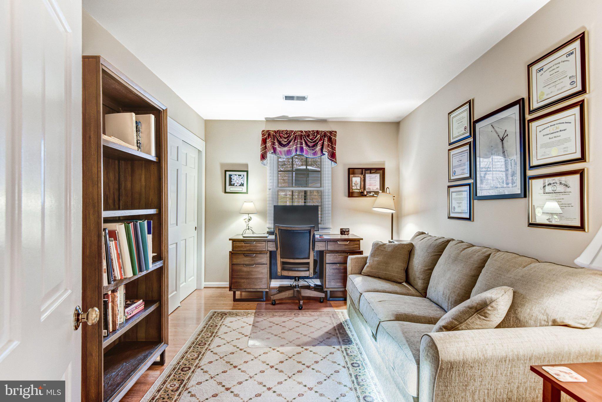 10111 Evans Ford Road Manassas, VA 20111 - Photo 22 of 35 a living room with fireplace furniture and a book shelf
