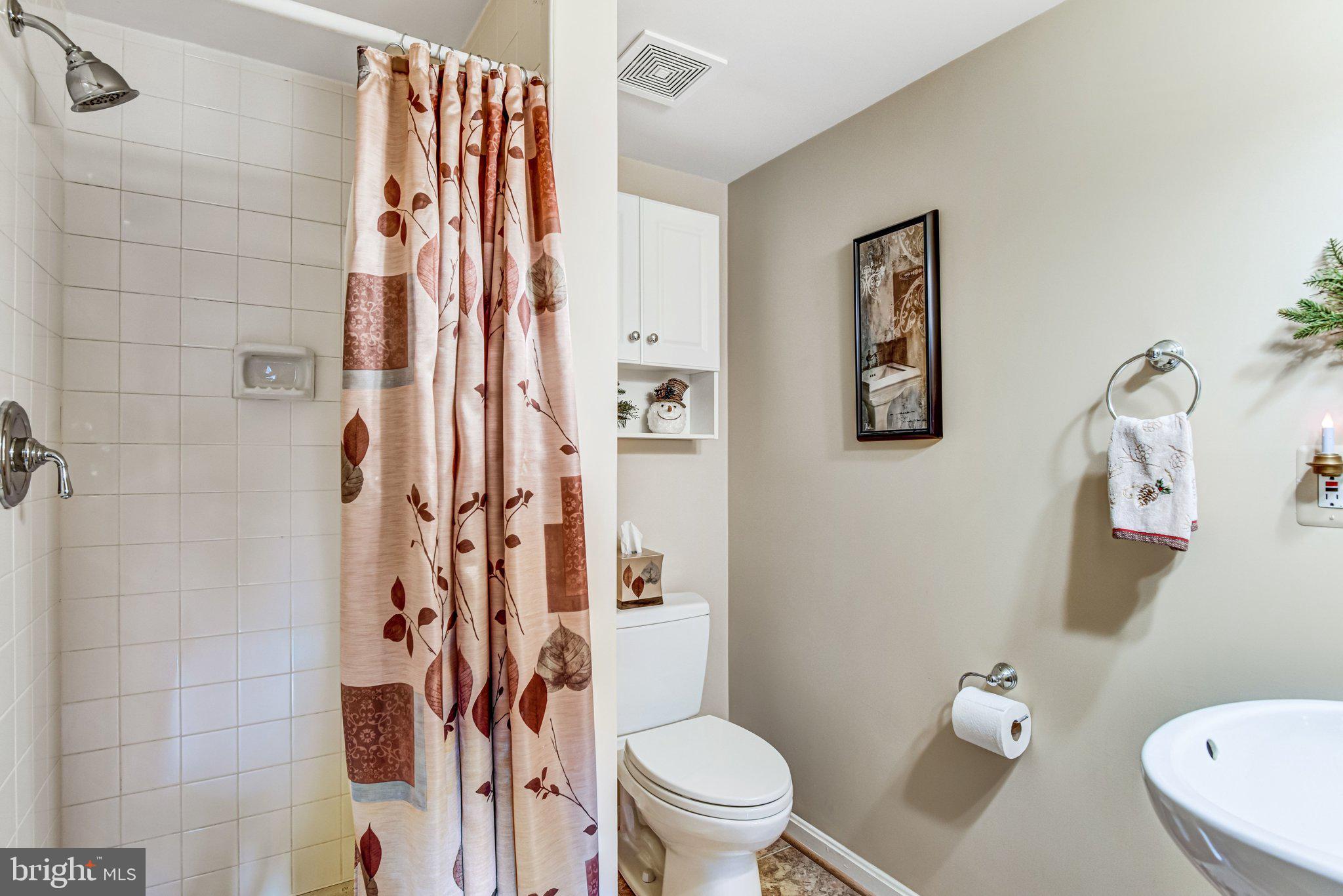 10111 Evans Ford Road Manassas, VA 20111 - Photo 24 of 35 a white toilet sitting next to a bathroom sink